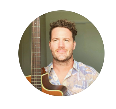 Musician Dom Francis next to a guitar in Mooloolaba