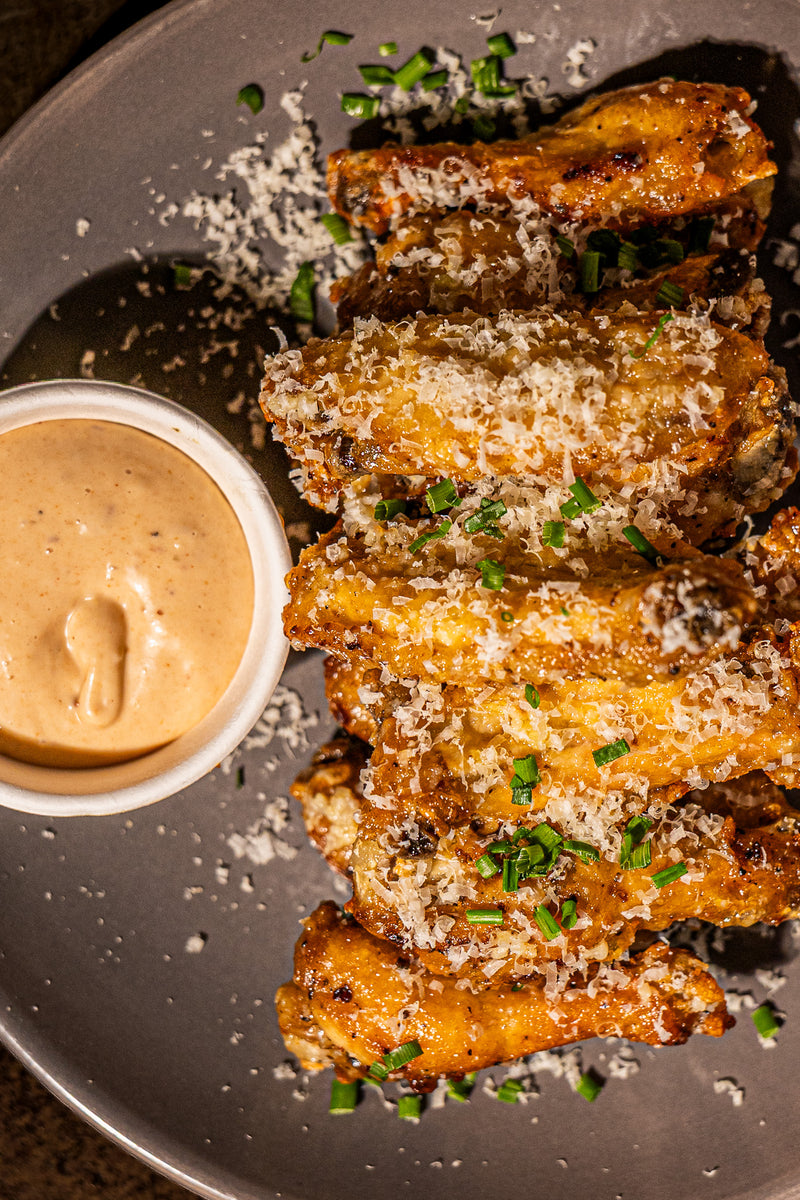 Parmesan Butter Garlic Wings with a chipotle mayo dipping sauce in Mooloolaba